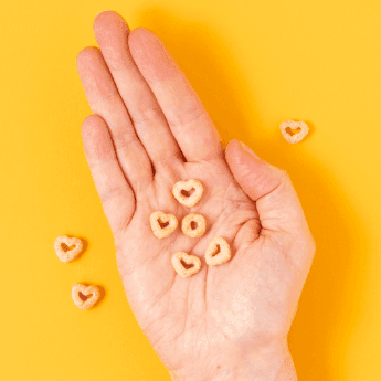 Instagram post featuring heart-shaped Cheerios in an open hand. - Link to social post